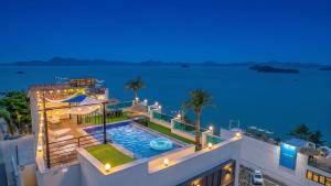 an aerial view of a house with a swimming pool at night at Yeosu Hemiswi SPA Pension in Yeosu