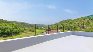 a balcony with a view of a mountain at Samcheok Greenhyang Pension in Samcheok +3 photos