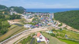 an aerial view of a town next to the ocean at Samcheok Greenhyang Pension in Samcheok