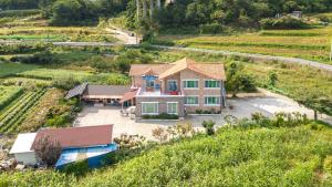 an aerial view of a house in a vineyard at Samcheok Greenhyang Pension in Samcheok