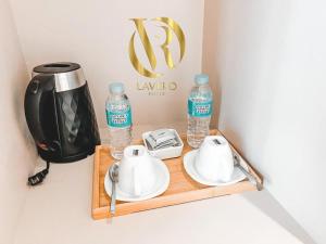a tray with two bottles of water and a tea kettle at LAVERO SUITES in Kalibo