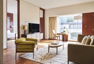 a living room with a couch and a table at Park Hyatt Zurich – City Center Luxury in Zurich