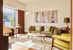 a living room with a couch and a table at Park Hyatt Zurich – City Center Luxury in Zurich