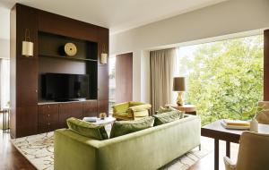 a living room with a couch and a tv at Park Hyatt Zurich – City Center Luxury in Zurich +100 photos