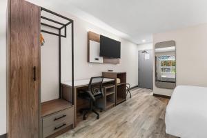 a bedroom with a desk and a bed and a desk at Comfort Inn in Bracebridge