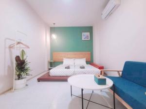 a room with a bed and a couch and a table at 7 Class Pool Villa in Chachoengsao +68 photos