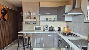 a kitchen with a stove and a counter top at VACANCES PAISIBLES - Option Menu & petit-déjeuners payant in Saint-Paul +27 photos