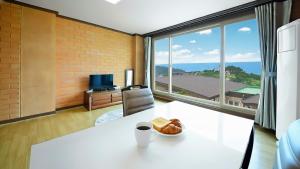 a room with a table with a plate of food on it at Yeosu Hwangto Pension in Yeosu