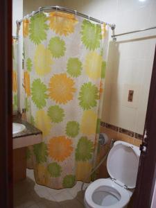 a bathroom with a toilet and a shower curtain at Phetsuwan Hotel in Phetchabun +153 photos
