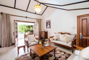 a living room with a couch and a table at PrideInn Flamingo Beach Resort & Spa Mombasa in Mombasa