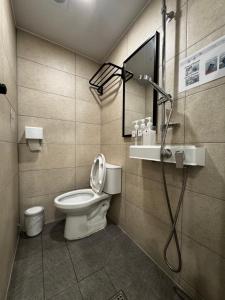 a bathroom with a toilet and a shower in it at Mega Stay Dongdaemun in Seoul