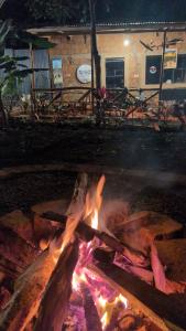 a fire pit in front of a building at night at Alkebulan cottages in Uru