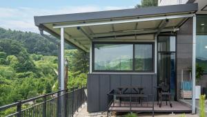 a tiny house with a view of the mountains at Gapyeong Nomadrium poolvilla Pension in Gapyeong