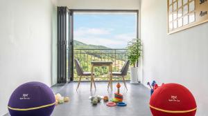 a room with a balcony with a table and chairs at Gapyeong Nomadrium poolvilla Pension in Gapyeong