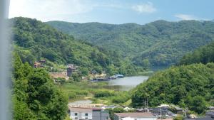 a view of a river in a valley with mountains at Gapyeong Nomadrium poolvilla Pension in Gapyeong +2 photos
