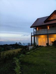 a house on the side of a hill with the lights on at Skye in Hortons in Pattipola +7 photos