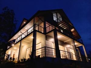 a large building with lights on at night at Skye in Hortons in Pattipola