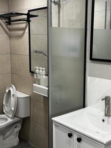 a bathroom with a toilet and a sink and a shower at Mega Stay Dongdaemun in Seoul