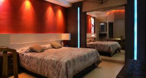 a hotel room with two beds and a mirror at Hotel Castelar suit in Castelar +3 photos