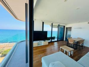a living room with a view of the ocean at Beachfront with pool and great views in Mataró