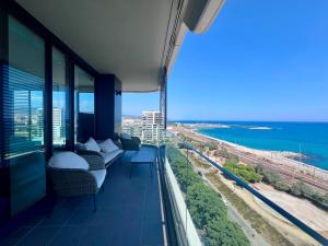 a room with a balcony with a view of the ocean at Beachfront with pool and great views in Mataró
