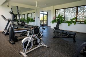 a gym with treadmills and exercise bikes in a room at Valletta Homes- Modern 1BR, 5mins walk to Serena Beach in Mombasa
