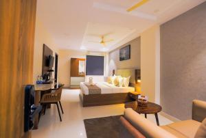 a hotel room with a bed and a living room at Rhyme Hotel - Hitech City in Hyderabad