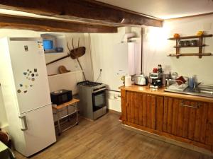 a kitchen with a white refrigerator and a stove at Casa Vintage 27 in Râşnov +17 photos