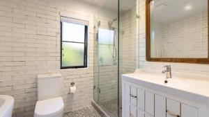 a bathroom with a toilet and a sink and a mirror at The Anchorage in New Brighton