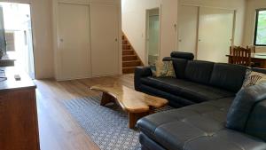 a living room with a couch and a coffee table at Hook Wine & Sinker in Brunswick Heads