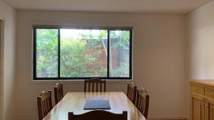 a dining room with a table and a large window at Hook Wine & Sinker in Brunswick Heads