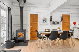 a dining room with a table and a wood stove at 0663-Toftlund-Midtparken-84 in Toftlund