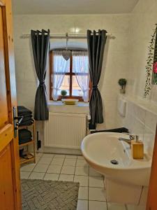 a bathroom with a sink and a window at Ferienhof Aiginger in Grafenau +42 photos
