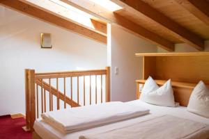 a bedroom with a bed with white pillows at Aparthotel Schindlhaus/Alpin in Söll