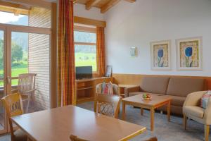 a living room with a couch and a table at Aparthotel Schindlhaus/Alpin in Söll