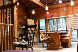 a room with chairs and a wooden table and a table at MOSAIC hinohara in Motojuku
