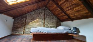 a bed in a room with a brick wall at Palazzo Gabela in Risan