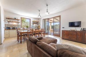 a living room with a couch and a table at Trulli Oasis in Noci
