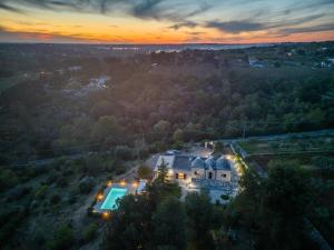 an aerial view of a house with a swimming pool at Trulli Oasis in Noci +26 photos