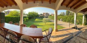 a wooden table and chairs on a patio at Garden View Apartment in Čapljina