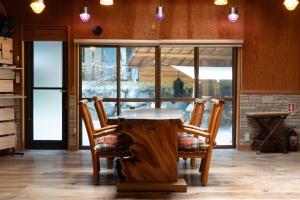 a table in a kitchen with two chairs around it at MOSAIC hinohara in Motojuku +33 photos