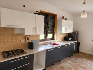 a kitchen with white cabinets and a counter top at Oko na Mogielice in Słopnice