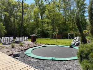 a small trampoline in a yard with a goal at Villa golf merignies in Mérignies