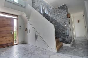 a hallway with a staircase and a door in a house at Villa golf merignies in Mérignies +13 photos
