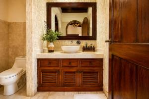 a bathroom with a sink and a toilet and a mirror at Nifu nifa in Antigua Guatemala +9 photos