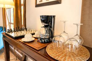 a table with a blender and wine glasses on it at Nifu nifa in Antigua Guatemala