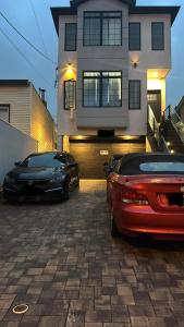 two cars parked in front of a house at La Suite de Antonio Shared Property PRIVATE stay NYC 18mins in North Bergen