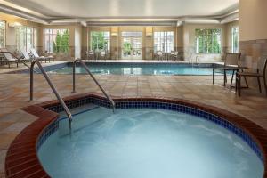 a pool in a hotel room with a hot tub at Homewood Suites New Brighton in Roseville
