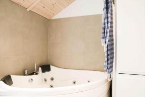 a bath tub in a bathroom with a shower at 11866-Nykobing-Sj-Skippervej-17 in Nyrup +16 photos