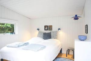 a bedroom with a white bed and a window at 13373-Asnaes-Radyrvej-24 in Asnæs